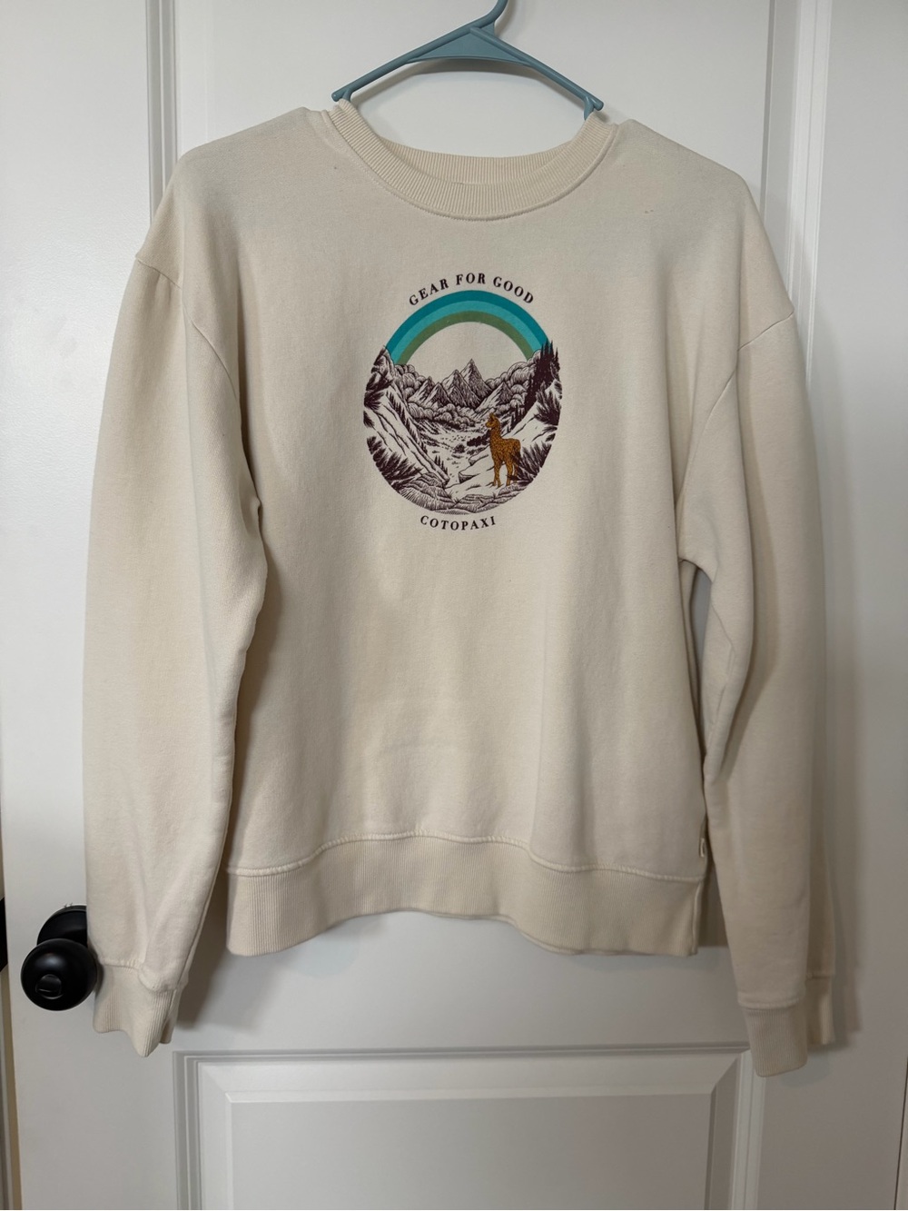 cotopaxi Cream Crewneck Sweatshirt with Mountain Graphic and Teal Accent